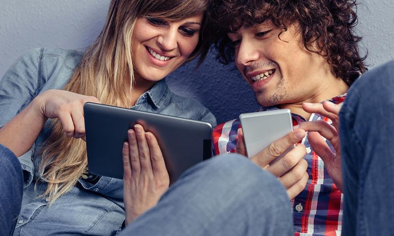 Couple Looking At Tablet