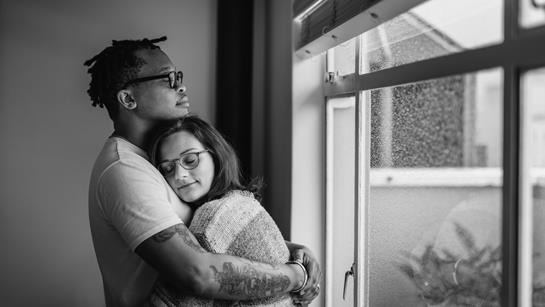Young Couple Hugging Near Window Greyscale