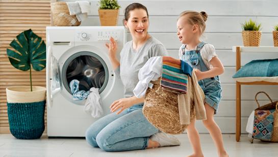 Mum And Child Doing The Washing Together