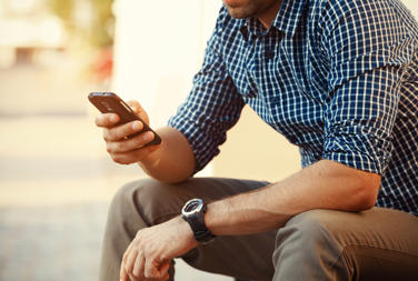 Young Man In Chequered Shirt On Phone