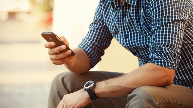 Young Man In Chequered Shirt On Phone