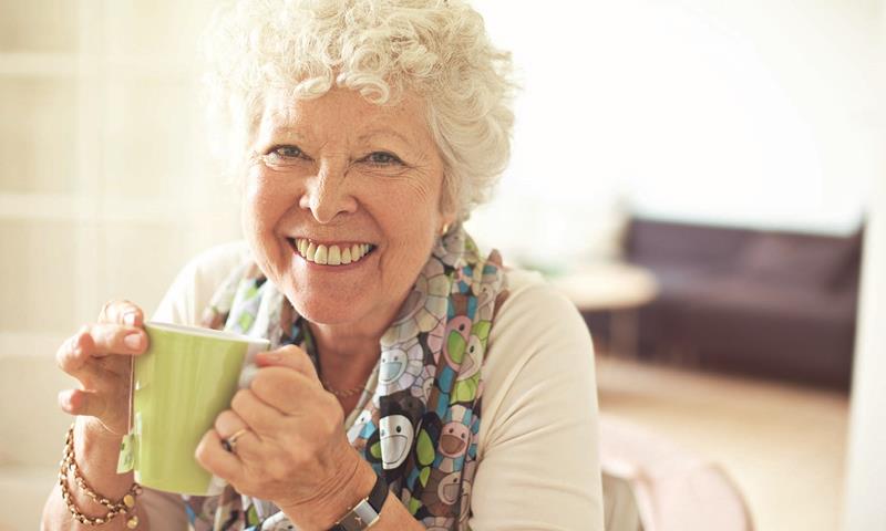 Older Lady Drinking Tea At Home