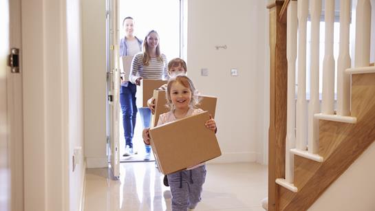 Young Family Moving In Children With Boxes