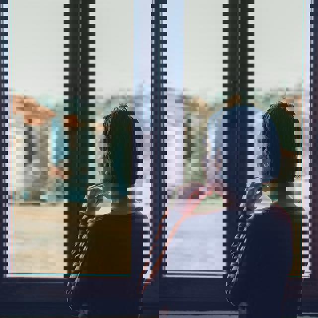 Woman At Home Stairing Out Of The Window