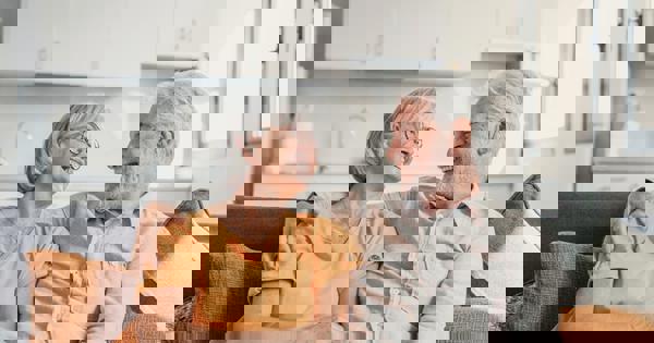 Older Couple Sat On The Sofa
