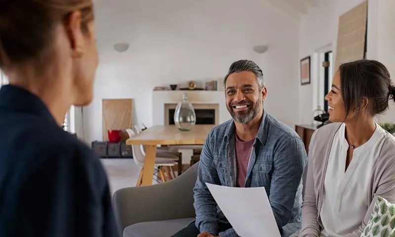 Couple Talking To Their Housing Officer In Their Home