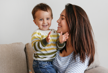 Woman And Child Sat On The Sofa