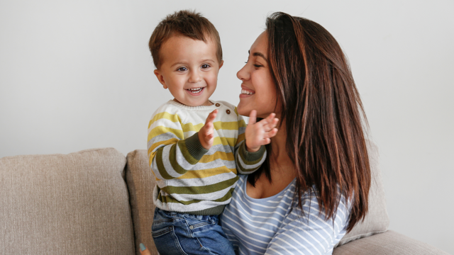 Woman And Child Sat On The Sofa